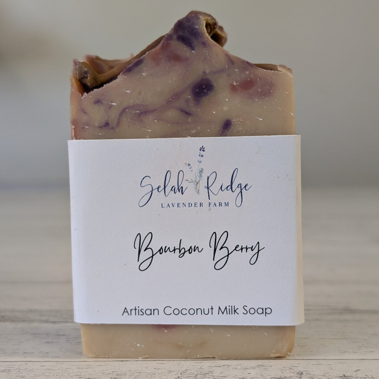 Artisan coconut milk soap with a label on a wooden surface