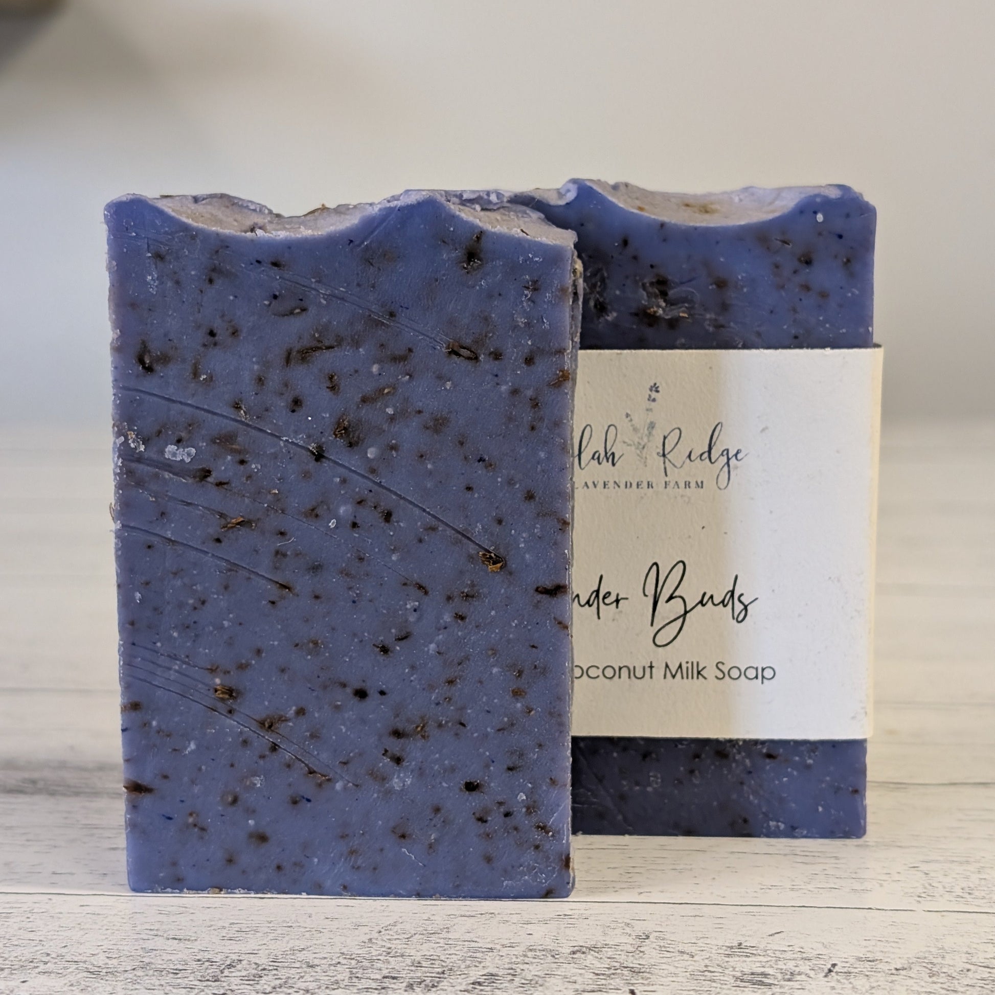 Blue speckled soap bar with a label on a wooden surface