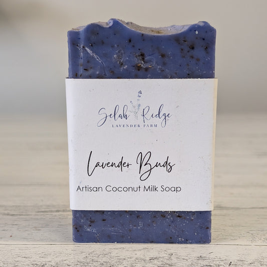 Artisan coconut milk soap with a label on a wooden surface