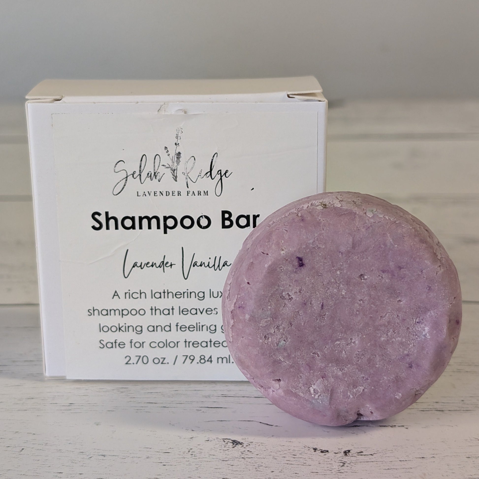 Purple shampoo bar with a white box labeled 'Sedona Ridge Shampoo Bar' on a wooden surface.