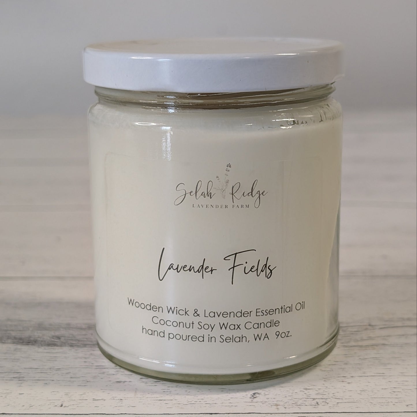 Candle jar labeled 'Lavender Fields' on a wooden surface