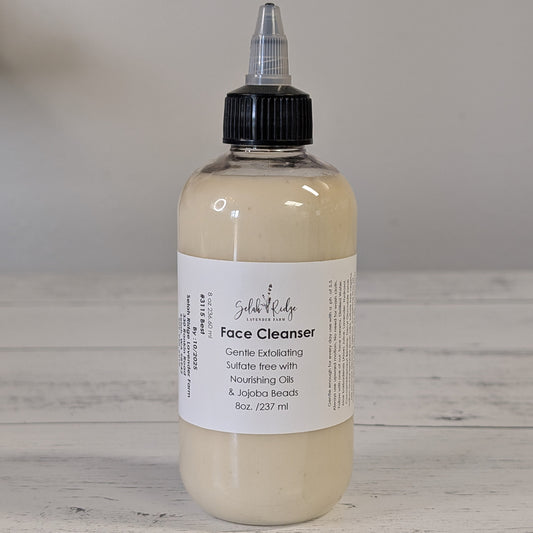 Bottle of face cleanser with a label on a wooden surface