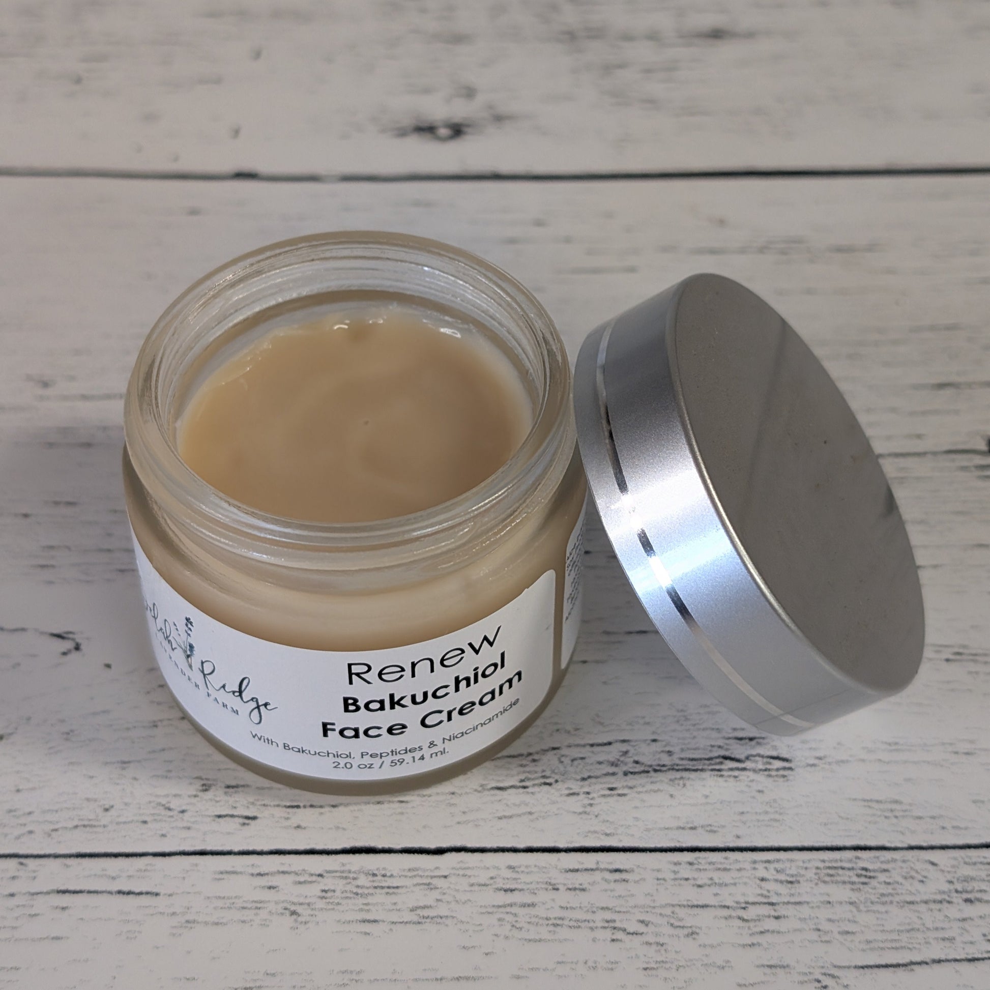Jar of Renew Bakuchiol Face Cream on a wooden surface