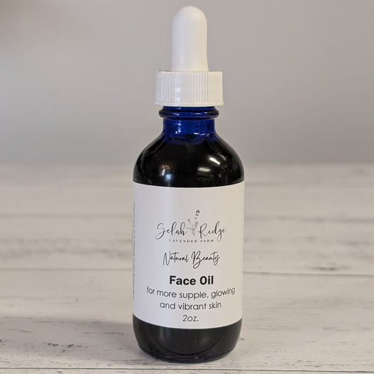 Bottle of face oil with dropper on a wooden surface