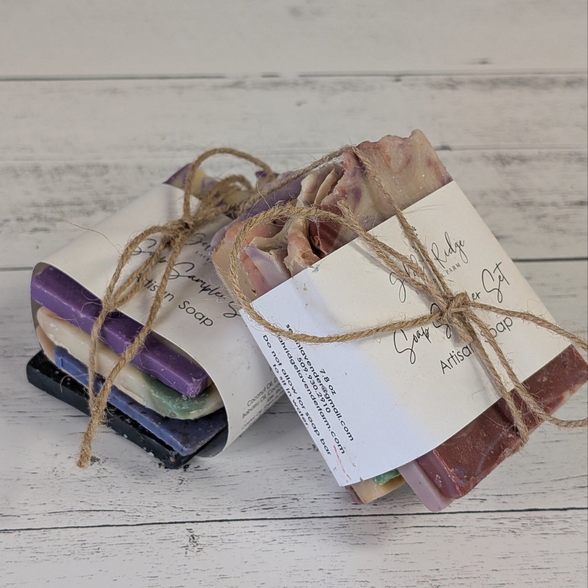 Set of handmade soap bars with labels tied with twine on a wooden surface