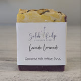 Coconut milk artisan soap with a label on a wooden surface